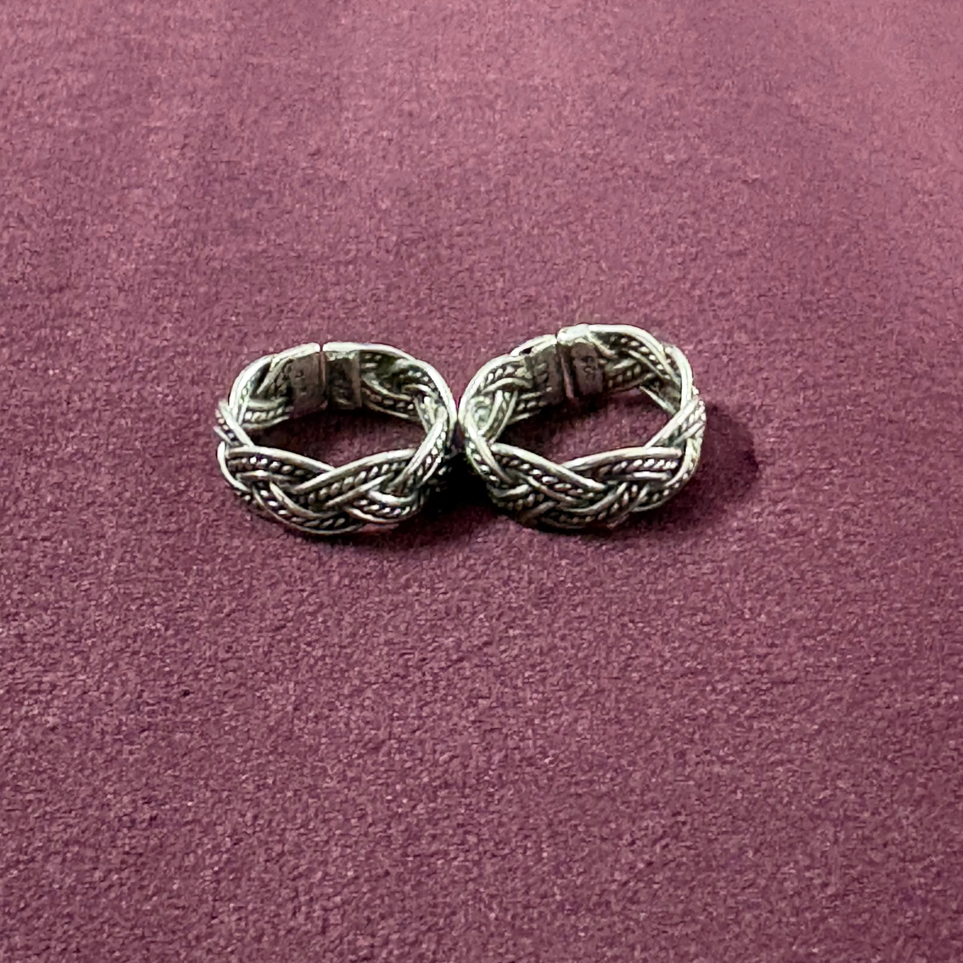 Braided Filigree Oxidized Band Toe Rings on maroon background