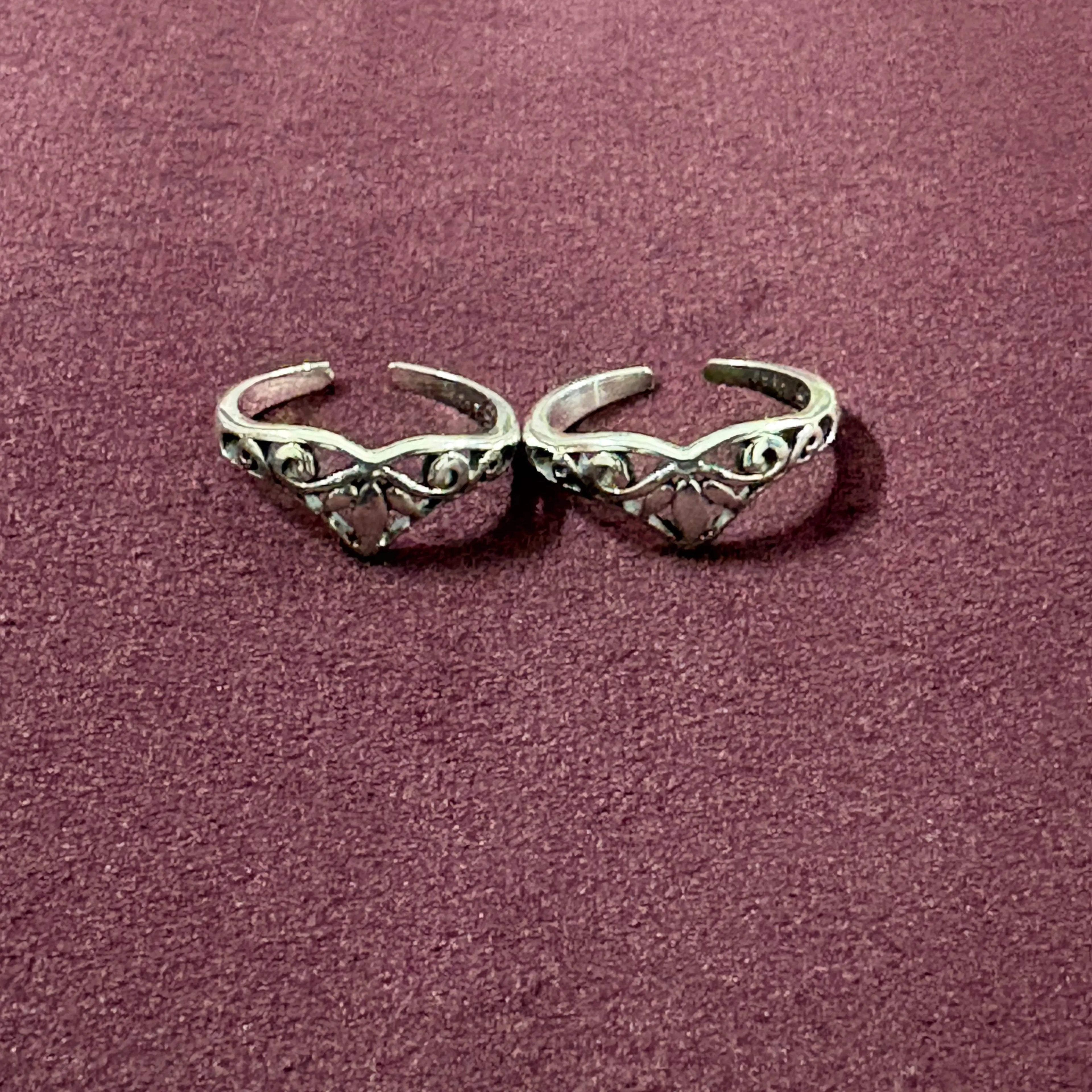 V-Shape Filigree Tiara Toe Rings on maroon background