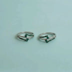 Dual Arch Emerald Toe Rings on solid background