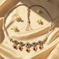 Sterling Silver necklace with red and clear beads on a beige fabric background