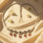 Sterling Silver necklace with red and clear beads on a beige fabric background