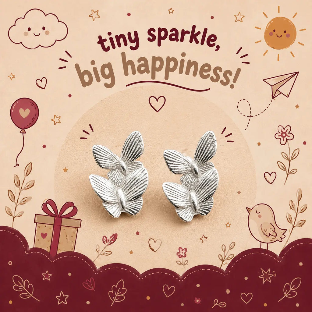 A pair of silver butterfly-shaped stud earrings displayed on a decorative illustrated backing card that reads 'tiny sparkle, big happiness!' with doodles of a sun, cloud, balloon, gift, bird, and stars.