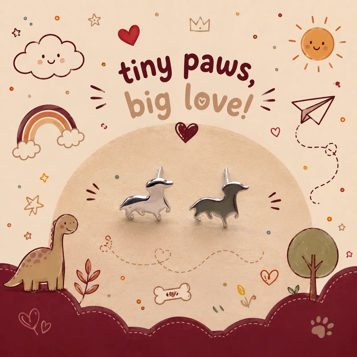 Two small puupy-shaped stud earrings displayed on a beige circular backdrop with whimsical illustrated decorations and the text 'tiny paws, big love!' above them.
