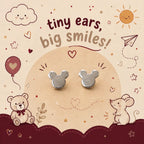 A pair of small silver stud earrings shaped like mouse ears, displayed on a beige card with cute teddy bear, mouse, sun, and cloud illustrations. The card reads 'tiny ears, big smiles!'.